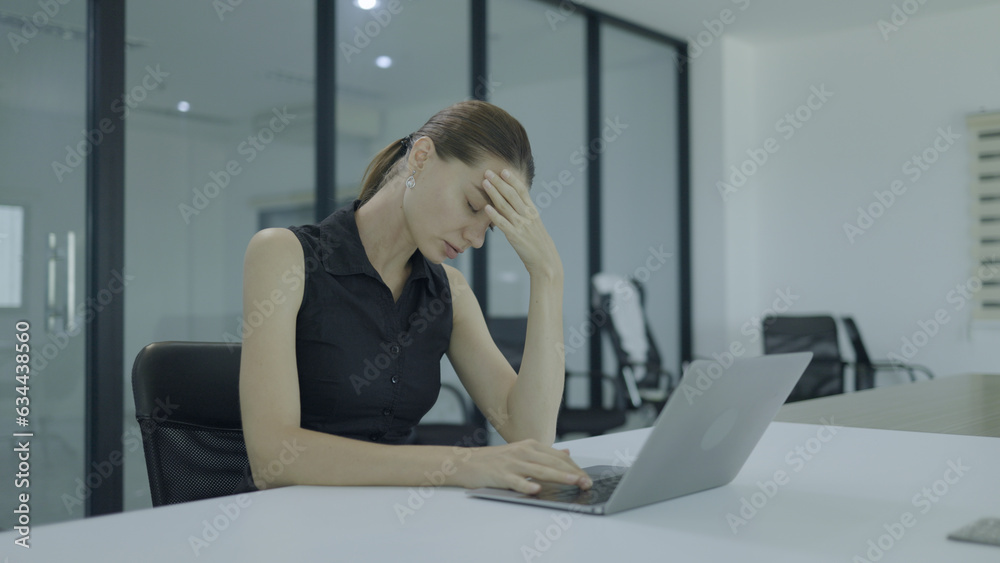 business female colleague with stress headache from overwork business female colleague with stress headache from overwork