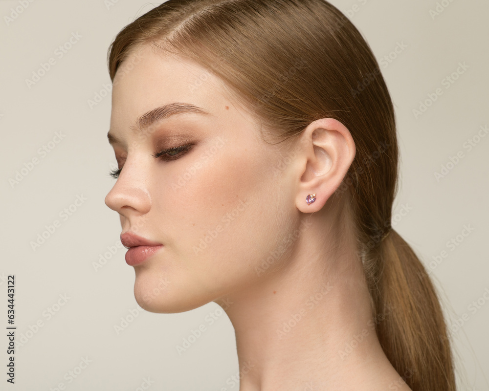 Close up portrait of a beautiful elegant woman with stylish jewelry on a white background. Beautiful girl with jewelry. Close up portrait of a beautiful elegant woman with stylish jewelry on a white background. Beautiful girl with jewelry.