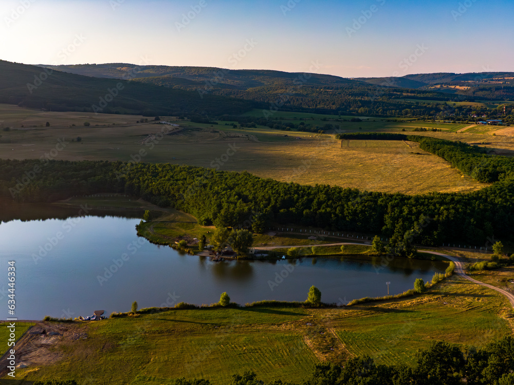 Aerial view of a lake from a Romanian Forest