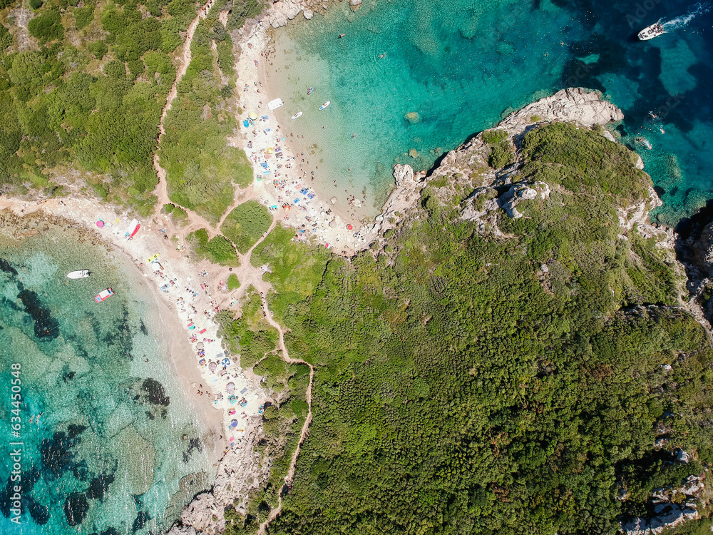 Drone view of Iconic beach of Porto Timoni (Agios Giorgios) in the Island of Corfu (Kerkira) in Greece, Europe. A path crosses this beach of the Ionic Sea.