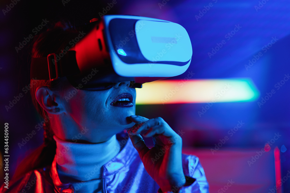 pensive modern business woman in vr headset on dark background pensive modern business woman in vr headset on dark background