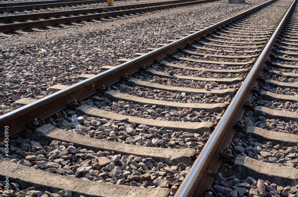 Close up of rusty railroad tracks with gravel stones Close up of rusty railroad tracks with gravel stones