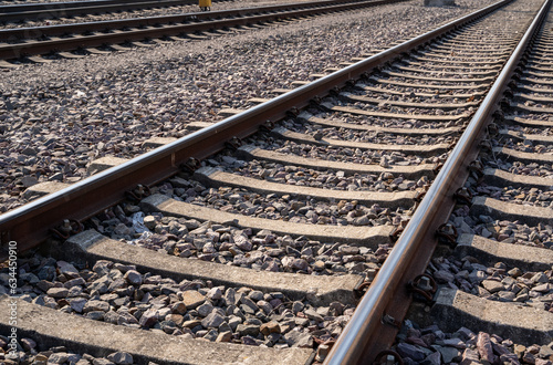 Close up of rusty railroad tracks with gravel stones