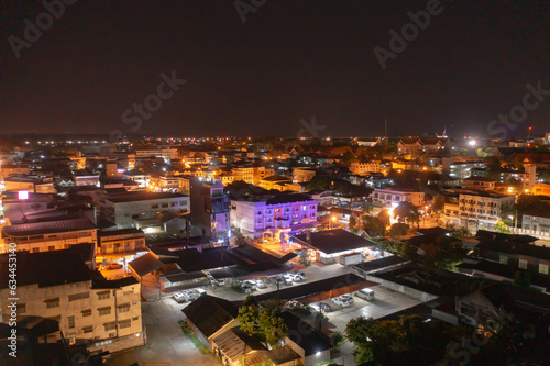 Aerial view of residential neighborhood roofs. Urban housing development from above. Top view. Real estate in Nakhon Phanom province city  Thailand. Property real estate at night.