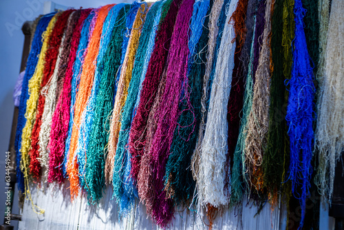 Woman is weaving beautiful carpet with Uzbekistan silk