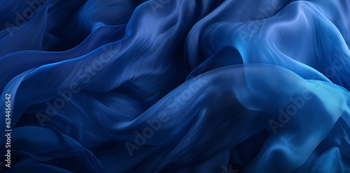 Aesthetic, elegant dark blue tulle fabric with waves on dark black background. Abstract fashion concept. 