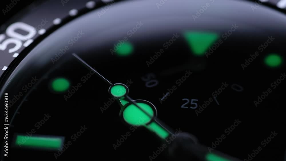 the second hand is ticking. Light flash on the turning clockface. Running second arrow. phosphor watch. phosphor watch. back light luxury watch under water. lume shot of a watch.