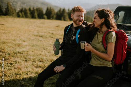 Young couple relaxing by a ...