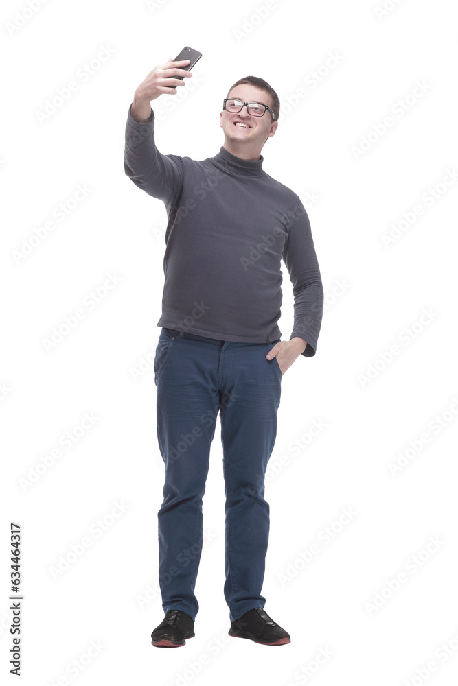 in full growth. casual young man with a smartphone.
