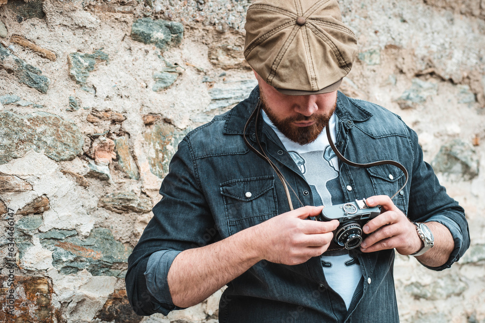 Portrait of a handsome guy with ivy hat standing, looking at his camera Portrait of a handsome guy with ivy hat standing, looking at his camera