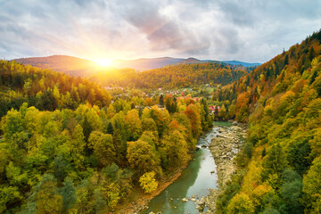 Leinwandbilder Honigfarbe aerial bird's-eye view of colorful forest, blue river and rocks. Drone shot. natural autumn landscape  © Ryzhkov Oleksandr