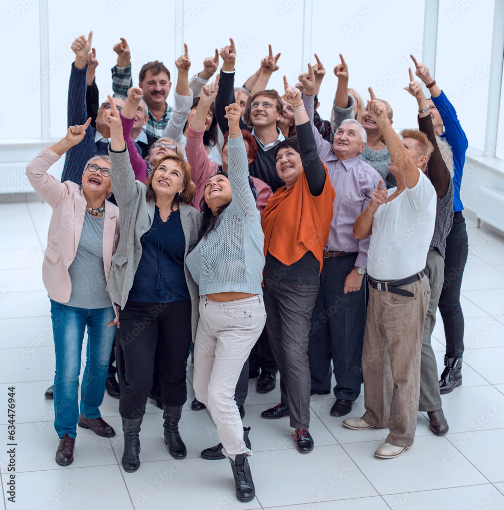 a group of older people raised their hands trying to reach