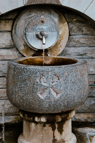 Water flowing from a spring through a tap. Religious place
