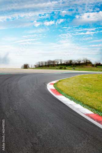 Motor sport asphalt race track and curbs with skid marks, low angle view