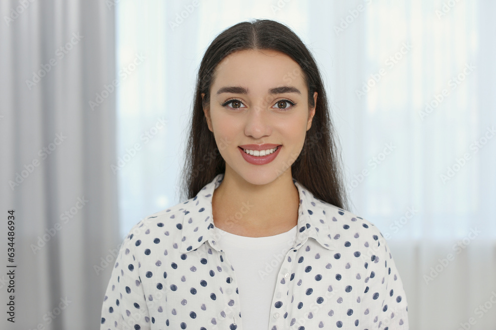 Portrait of beautiful young woman at home