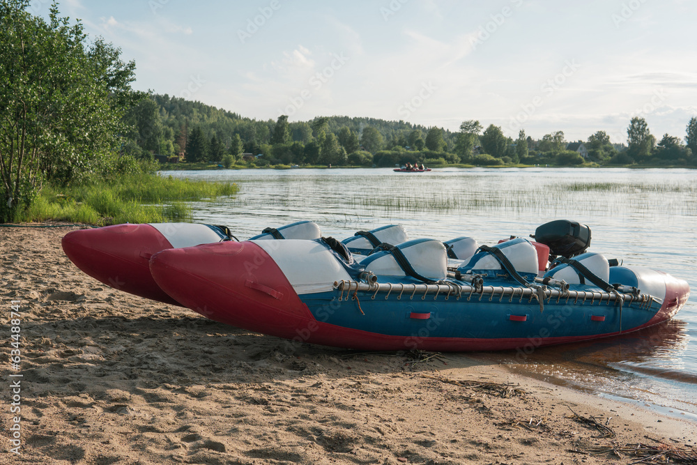 Fototapeta premium inflatable raft-catamaran for whitewater sports is moored on the river bank