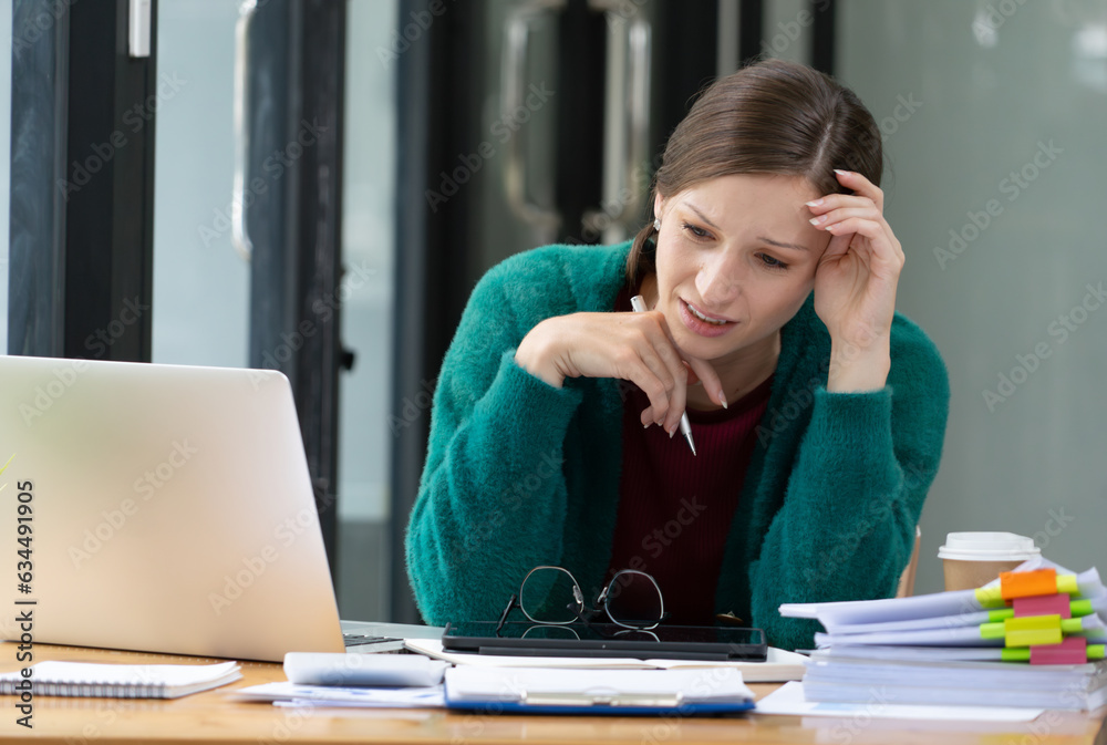 Young attractive Asian business woman sleeping, drowsing or taking a nap at her desk, Tired business woman accountant with bills and paper folders in office, tired young business woman with laptop. Young attractive Asian business woman sleeping, drowsing or taking a nap at her desk, Tired business woman accountant with bills and paper folders in office, tired young business woman with laptop.