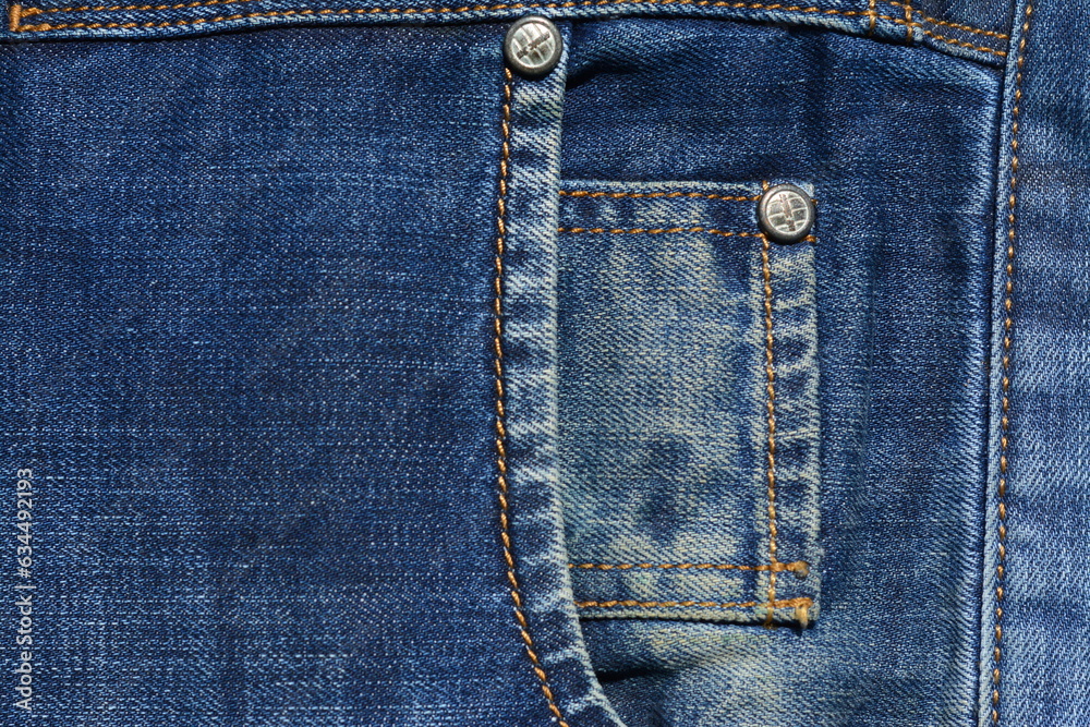Double pocket with studs in blue jeans. View from above Double pocket with studs in blue jeans. View from above