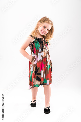 Little girl posing on a light background