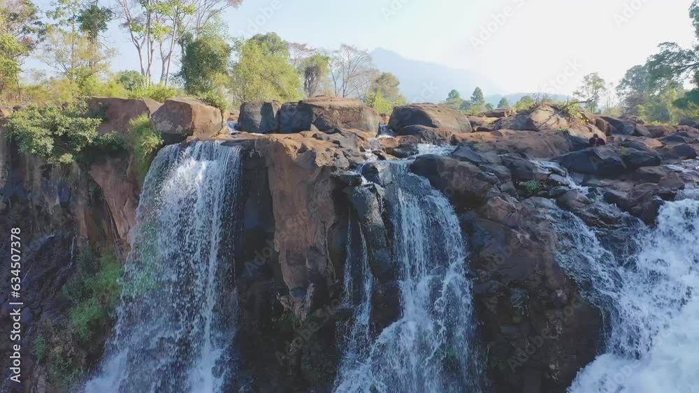 Slow revealing view Tad Lo waterfall in Boloven Plateau, Laos. Local ...