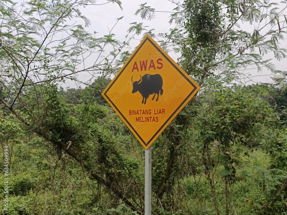 Warning sign on the road in malaysia. This sign is used to warn drivers of dangerous animals.photo taken in malaysia