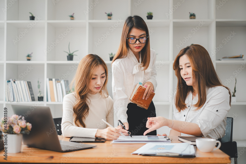 Female operations manager holds meeting presentation for a team of economists. Asian woman uses business paper with Growth Analysis, Charts, Statistics and Data.. Female operations manager holds meeting presentation for a team of economists. Asian woman uses business paper with Growth Analysis, Charts, Statistics and Data..
