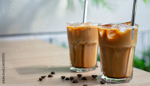 Iced caramel macchiato coffee in glass with stainless steel straw for drink. Concept for reduce plastic pollution and support green eco friendly products. selective focus