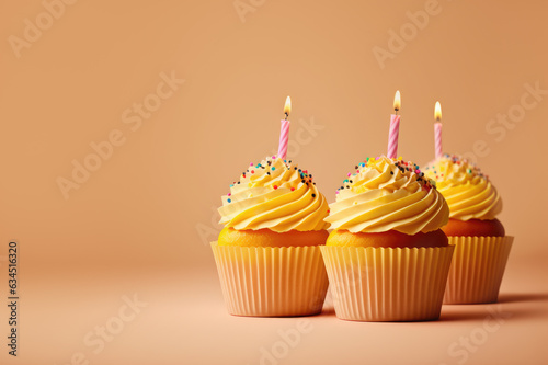 cupcake with candle on yellow background