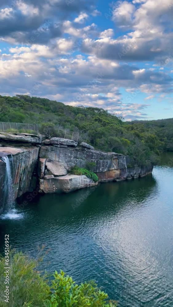 4k Video -Panning views from above at sunset from the top of the waterfall over the lagoon and the ocean further away at Wattamolla Beach in Royal National Park, NSW, Australia. 4k Video -Panning views from above at sunset from the top of the waterfall over the lagoon and the ocean further away at Wattamolla Beach in Royal National Park, NSW, Australia.