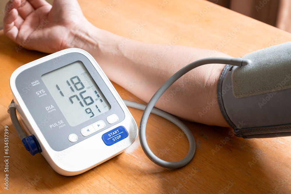 Man check blood pressure monitor and heart rate monitor with digital pressure gauge. Health care and Medical concept Man check blood pressure monitor and heart rate monitor with digital pressure gauge. Health care and Medical concept