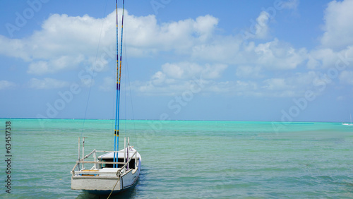 fishing boat in beautiful light blue sea with clouds, bawean island, indonesia © agung