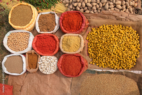 Colorful spices displayed in an informal rural outdoor market, India.