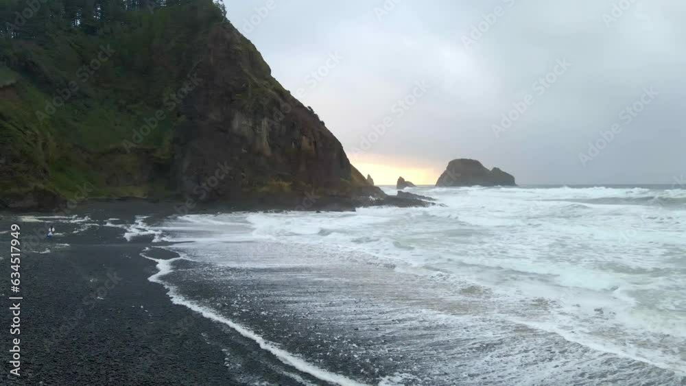 Rocky beach surrounded by cliffs and forest in Oregon coastline on a cloudy day aerial view Rocky beach surrounded by cliffs and forest in Oregon coastline on a cloudy day aerial view
