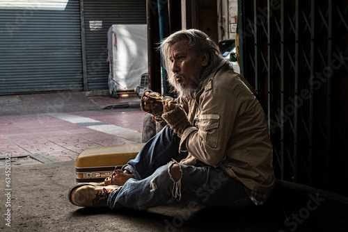 Fotografija Crisis homeless aged man upset, stress no money sitting on sidewalk street, unem