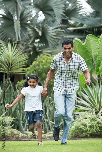 Happy Indian dad and his child playing outdoors