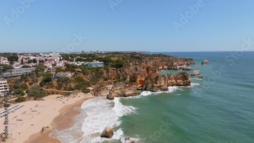 Sand volleyball courts and bungalows on scenic algarve portugal beach, aerial
