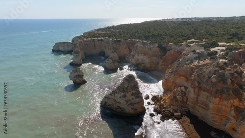 Panoramic aerial wide view of Praia da Marinha, seagulls soar above coastline, Algarve Portugal photo