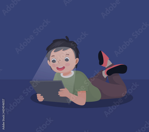 little boy using smartphone lying on the floor at night in the darkroom