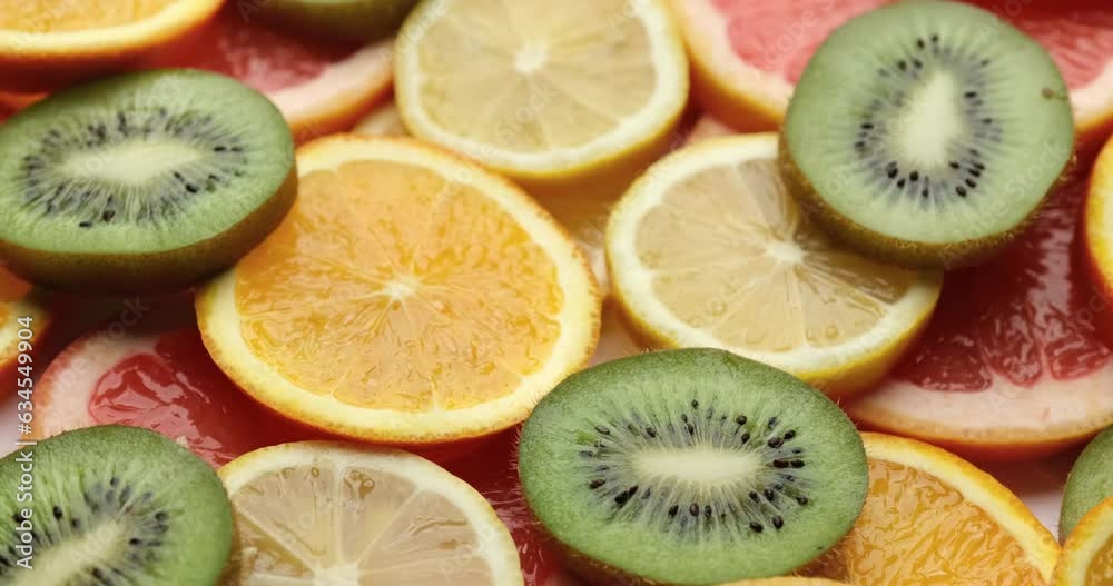 top down background view made of Fresh Sliced organic kiwi, oranges and lemons close-up top down background view made of Fresh Sliced organic kiwi, oranges and lemons close-up