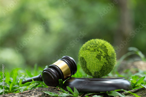 Green World and gavel with scales of justice on a green background. Environment Law. legal force or certification for the survival of all mankind with international Environmental law.International Law