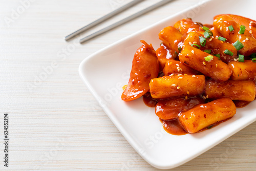 Korean rice cake stick with sausage in spicy sauce - Tteokbokki photo