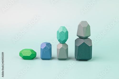 Concept of growth. Wooden blocks on a green background.