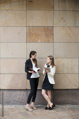 Two Businesswomen using digital tablet computer.