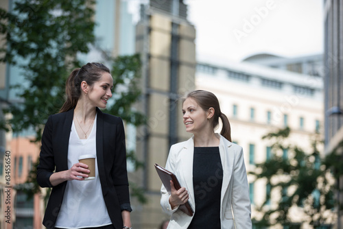 Two happy businesswomen talking