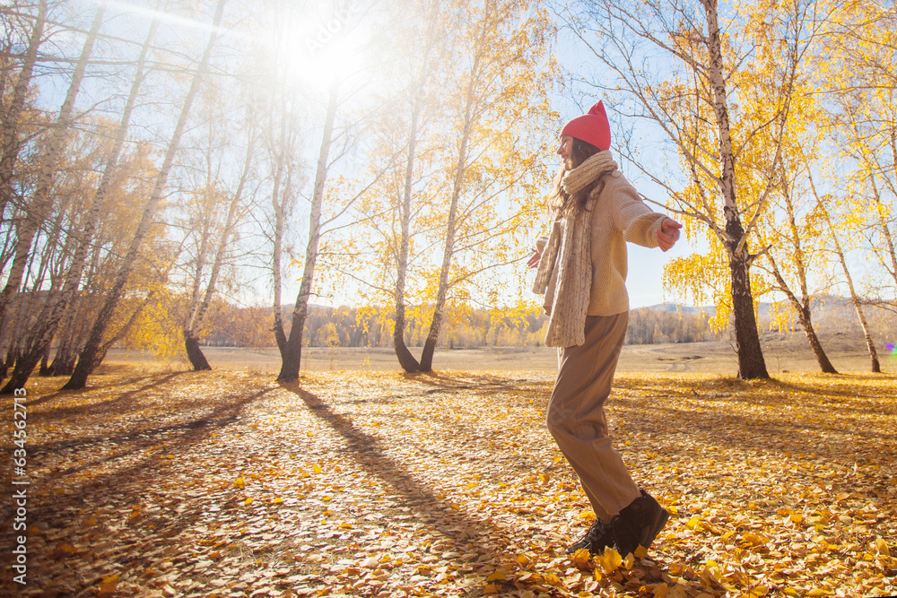 Young woman in the autumn weather in warm clothes and hats