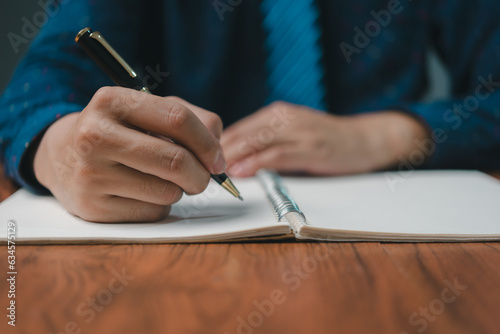 Hand holding pen checklist paper work on desk. Signing information contract and agreement. Checkbox report questions customer services. Write education and learning homework.