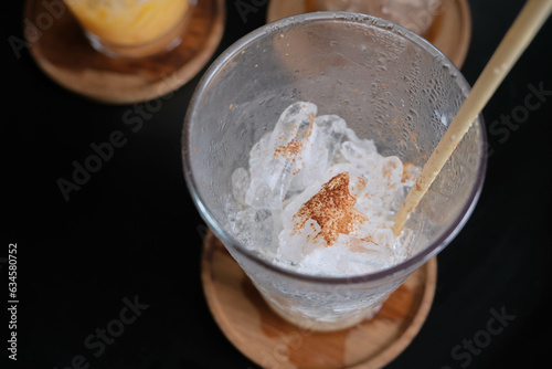 Top view of empty iced coffee glass on the wood coasters.