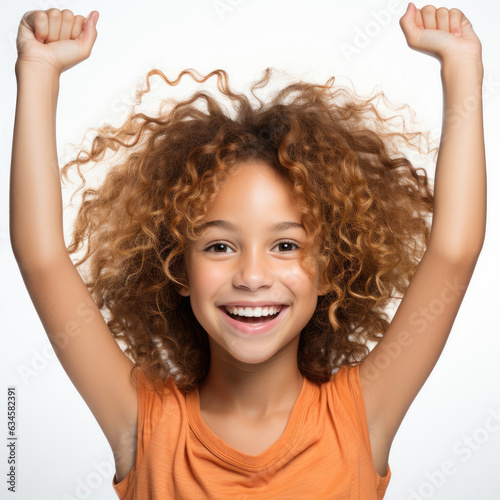 A professional studio head shot of a jubilant 12-year-old Panamanian girl with her hands raised in glee.