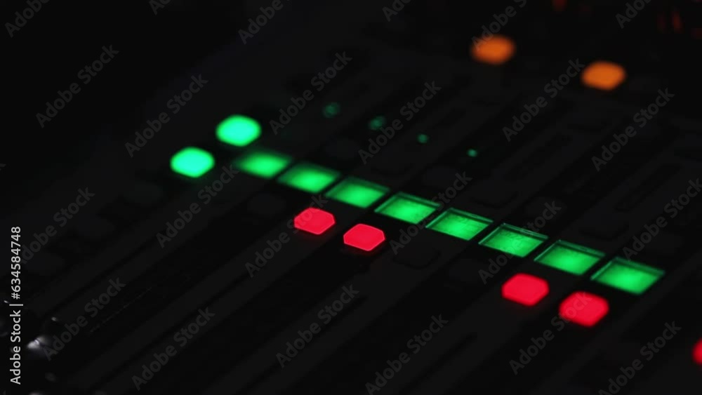 Professional instrumental sound engineer in the studio or at a concert. Close-up music digital mixer. Audio control panel console, audio mixing buttons and sliders while, sound system. Professional instrumental sound engineer in the studio or at a concert. Close-up music digital mixer. Audio control panel console, audio mixing buttons and sliders while, sound system.