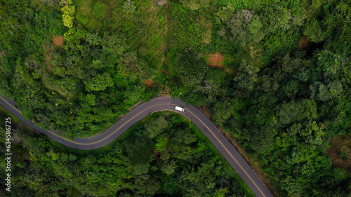 Top-down photograph of a road with car